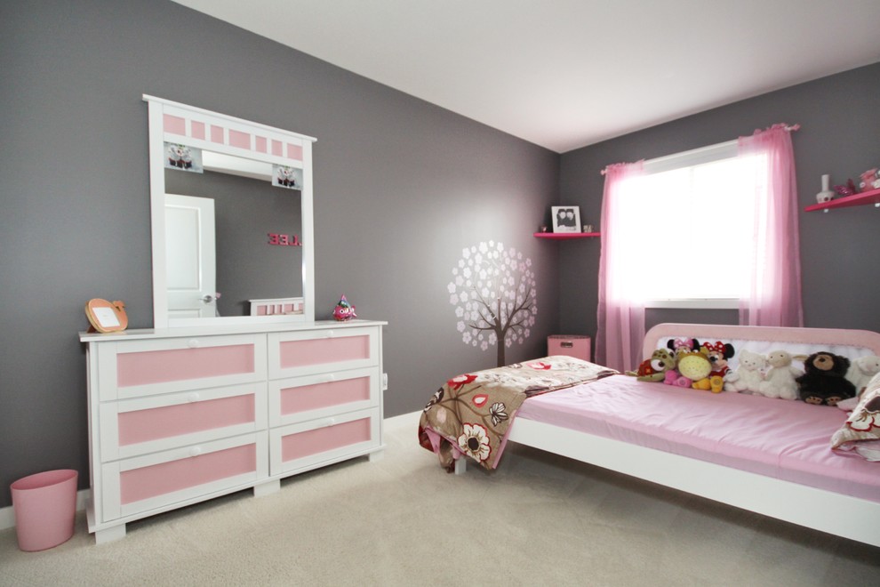 This is an example of a mid-sized modern kids' bedroom for girls in Other with carpet.