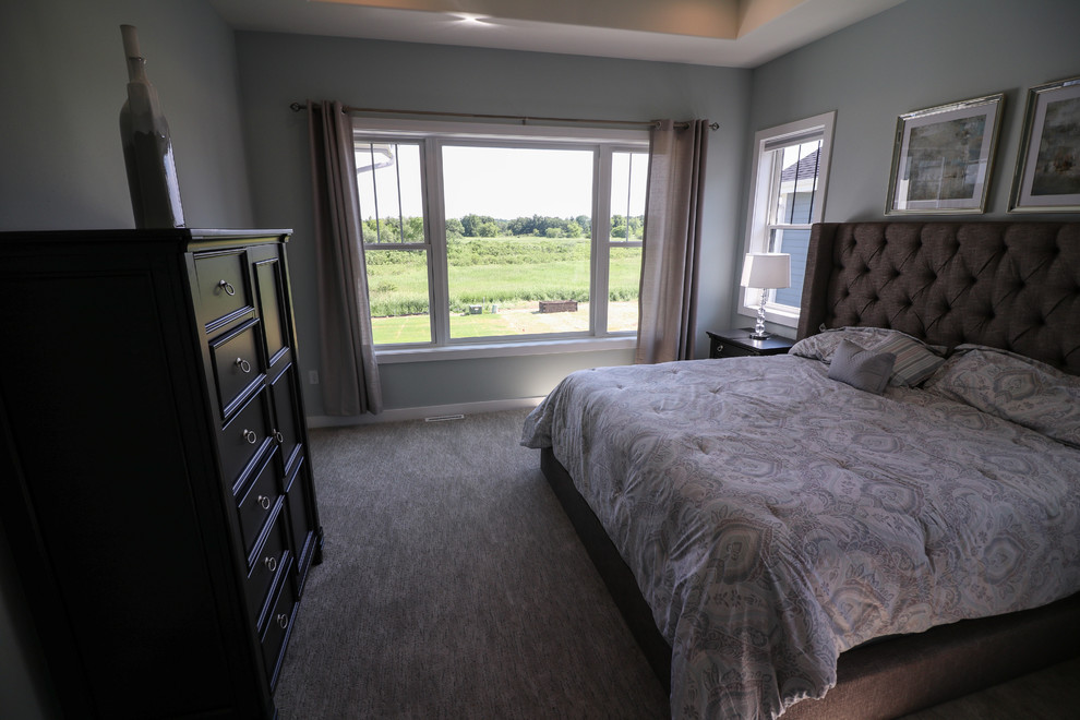 This is an example of a large eclectic master bedroom in Other with grey walls, carpet, no fireplace and grey floor.