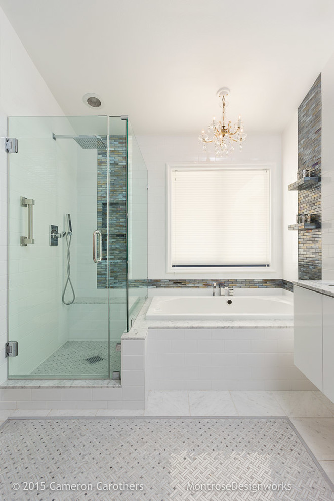 This is an example of a mid-sized contemporary master bathroom in Los Angeles with an undermount sink, flat-panel cabinets, white cabinets, marble benchtops, a drop-in tub, a corner shower, white tile, subway tile, blue walls and marble floors.