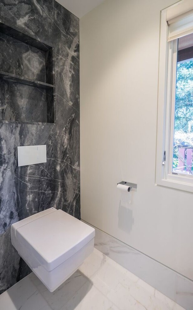Inspiration for a large contemporary powder room in San Francisco with flat-panel cabinets, dark wood cabinets, blue tile, gray tile, white tile, pebble tile, white walls, marble floors, a drop-in sink, quartzite benchtops, a wall-mount toilet and white floor.