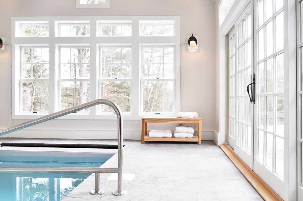 Design ideas for a small traditional indoor rectangular pool in Burlington with a pool house and stamped concrete.