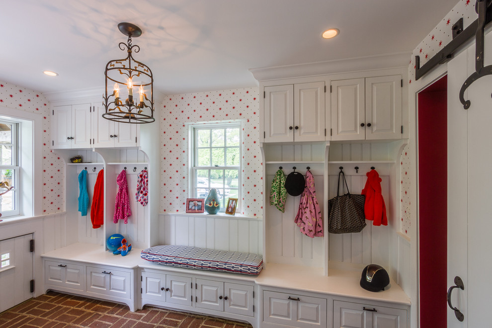 Inspiration for a country mudroom in Philadelphia with multi-coloured walls and brick floors.