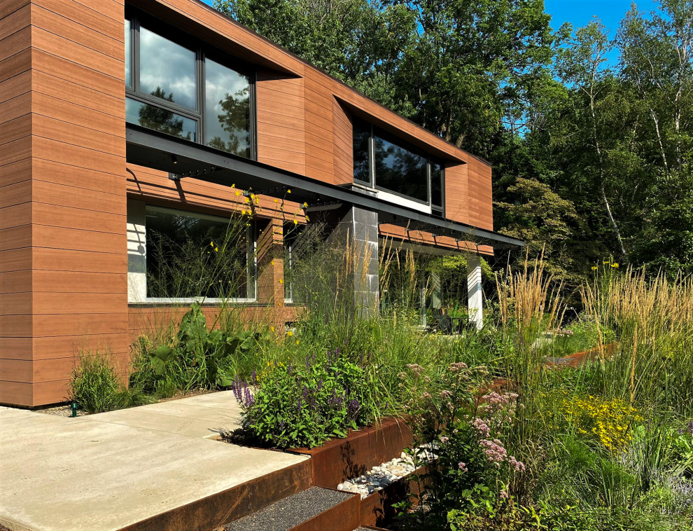 Esempio di un grande giardino minimalista esposto in pieno sole dietro casa in estate con ghiaia