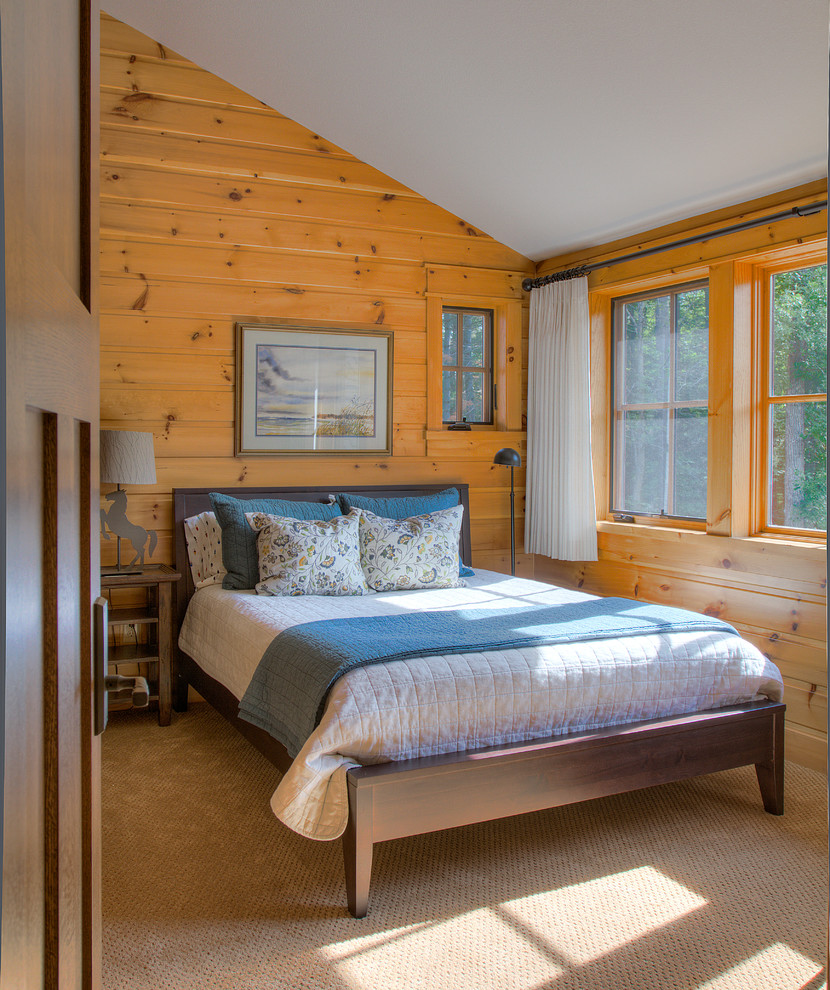 This is an example of a country bedroom in Minneapolis with brown walls, carpet and beige floor.