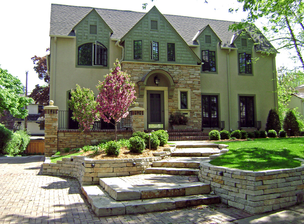 Photo of a mid-sized traditional front yard full sun driveway in Minneapolis with a garden path and natural stone pavers.
