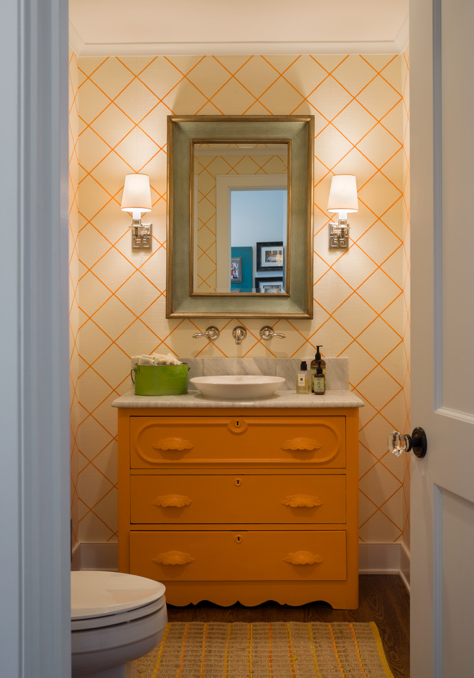Photo of a beach style powder room in Providence with a vessel sink, furniture-like cabinets, orange cabinets and grey benchtops.