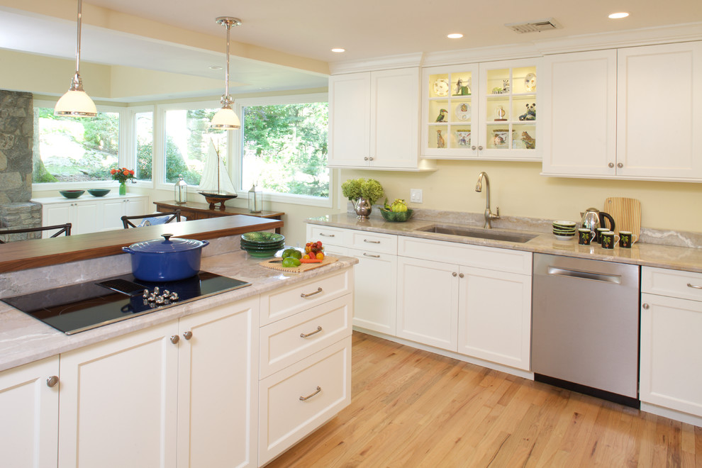 Inspiration for a mid-sized transitional l-shaped light wood floor eat-in kitchen remodel in New York with recessed-panel cabinets, quartzite countertops, stainless steel appliances, an island, an undermount sink and white cabinets