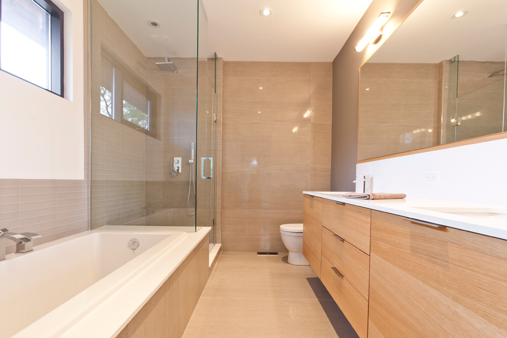 Inspiration for a modern bathroom in Toronto with flat-panel cabinets, light wood cabinets, a drop-in tub and a corner shower.