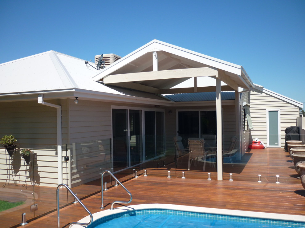 Photo of a mid-sized beach style backyard deck in Melbourne with a pergola.