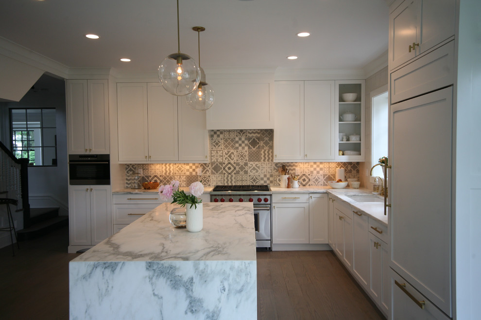 Eat-in kitchen - large transitional u-shaped medium tone wood floor and brown floor eat-in kitchen idea in New York with an undermount sink, shaker cabinets, white cabinets, marble countertops, multicolored backsplash, ceramic backsplash, paneled appliances and an island
