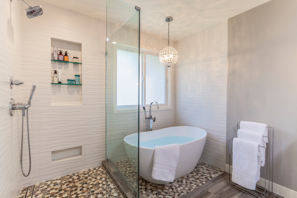 Photo of a large transitional master bathroom in Los Angeles with a freestanding tub, white tile, ceramic tile, grey walls, pebble tile floors, a corner shower and a hinged shower door.