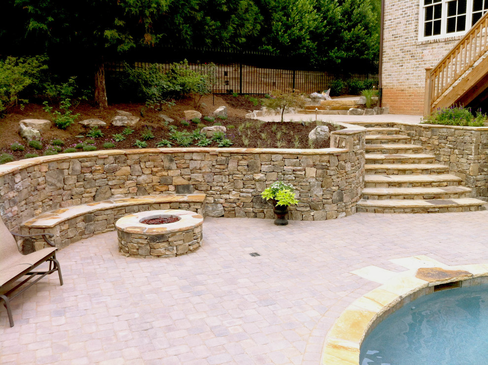 Mid-sized traditional side yard patio in Atlanta with a fire feature, brick pavers and no cover.