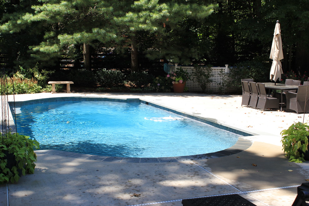 Large traditional backyard pool in DC Metro with concrete slab.