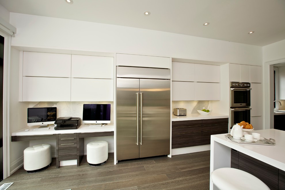 Design ideas for a contemporary l-shaped eat-in kitchen in Toronto with flat-panel cabinets, white cabinets, white splashback and stainless steel appliances.