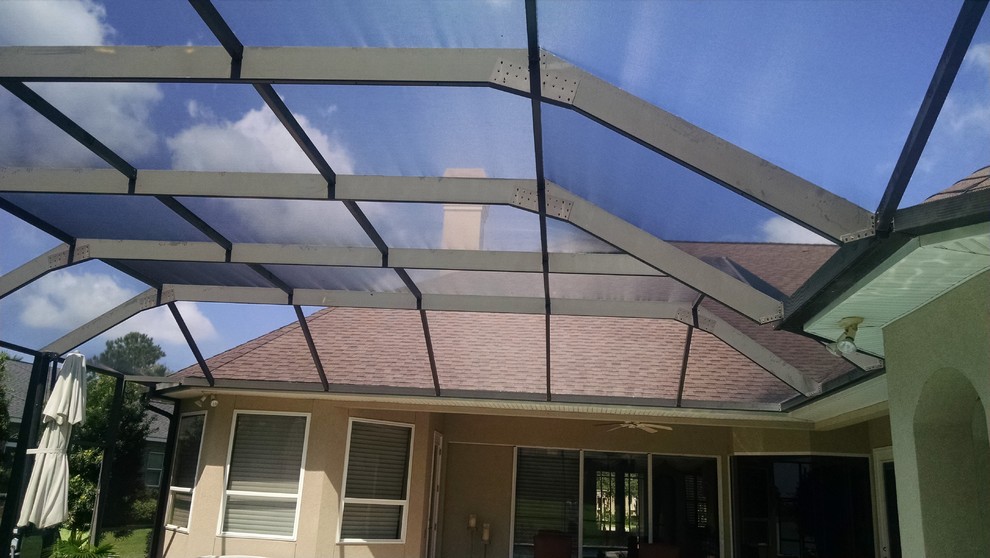 Example of a large transitional backyard stone and custom-shaped hot tub design in Miami