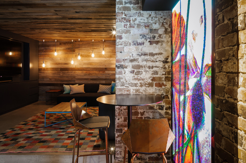 Mid-sized industrial single-wall seated home bar in Sydney with concrete floors, an undermount sink, grey splashback, mirror splashback and grey floor.