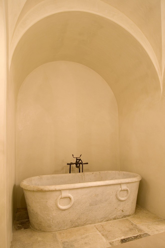 Inspiration for a mediterranean bathroom in Houston with a freestanding tub.