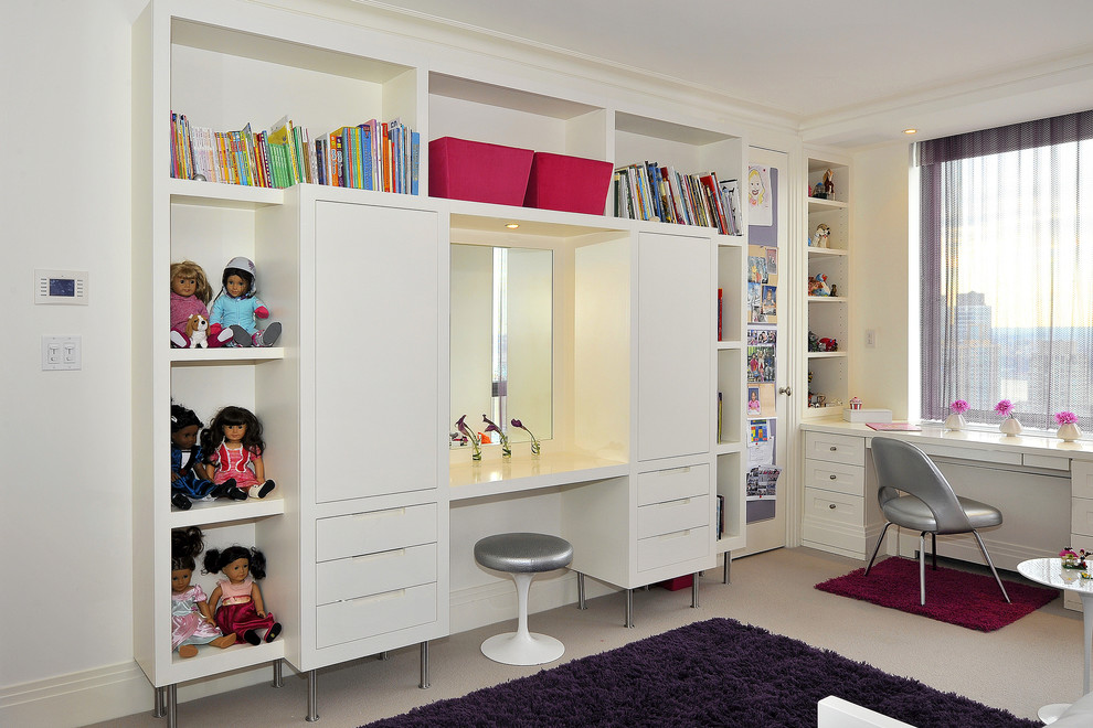 This is an example of a contemporary kids' room for girls in New York with white walls and carpet.