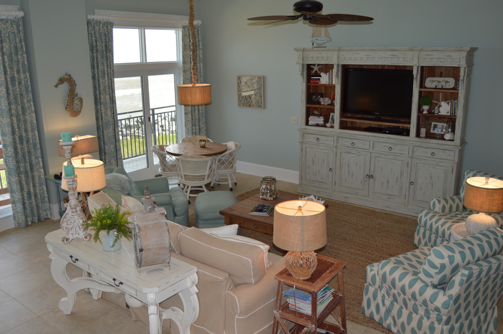 Design ideas for a mid-sized beach style enclosed living room in Atlanta with blue walls, limestone floors, no fireplace, a built-in media wall and beige floor.