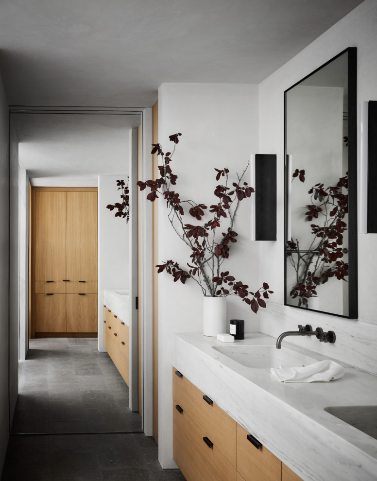 Medium sized contemporary ensuite bathroom in San Francisco with light wood cabinets, grey floors, grey worktops, double sinks, a built in vanity unit, white walls, an integrated sink and marble worktops.