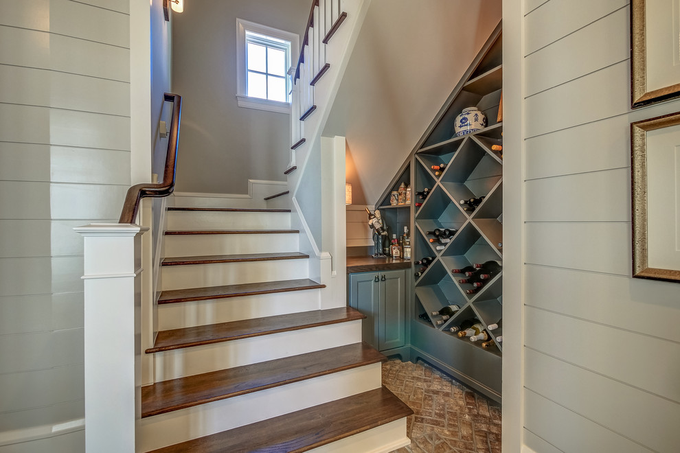 Transitional wood u-shaped staircase in Atlanta with painted wood risers and wood railing.