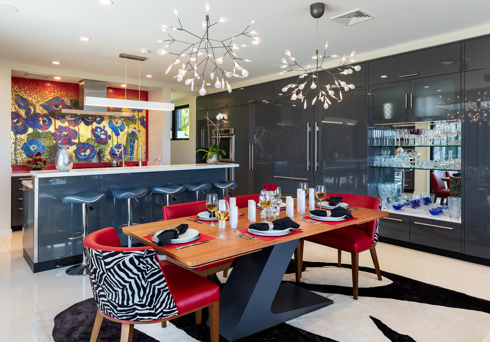 Large modern u-shaped eat-in kitchen in Hawaii with flat-panel cabinets, grey cabinets, solid surface benchtops, multi-coloured splashback, mosaic tile splashback, panelled appliances, with island, white floor and white benchtop.