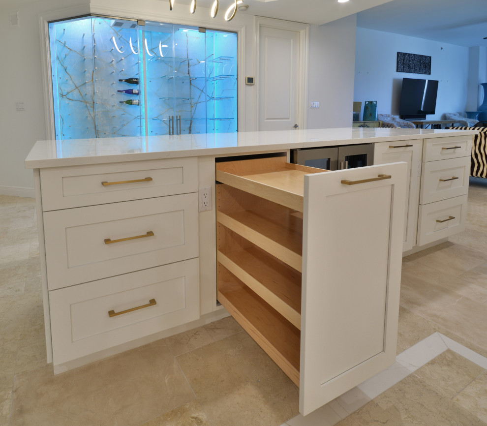 This is an example of a large transitional u-shaped eat-in kitchen in Miami with an undermount sink, shaker cabinets, white cabinets, quartz benchtops, multi-coloured splashback, ceramic splashback, white appliances, travertine floors, with island, beige floor, white benchtop and coffered.