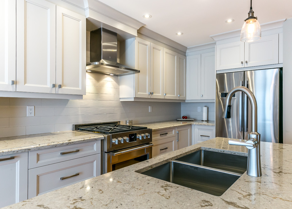 Kitchen - mid-sized transitional l-shaped brown floor kitchen idea in Toronto with a double-bowl sink, white cabinets, white backsplash, stainless steel appliances and an island