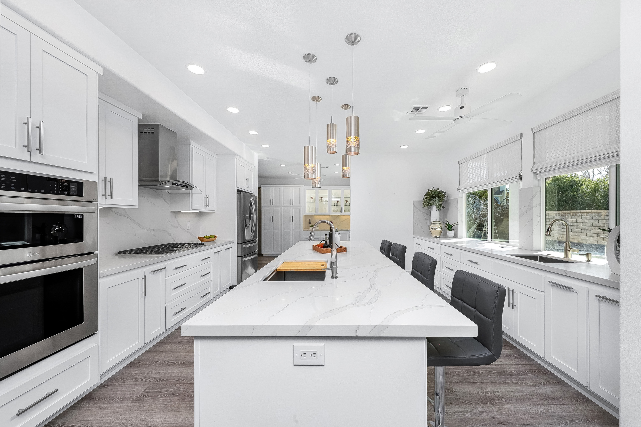 Custom White Shaker Cabinetry Kitchen with Veined Quartz Countertops and Full Sp