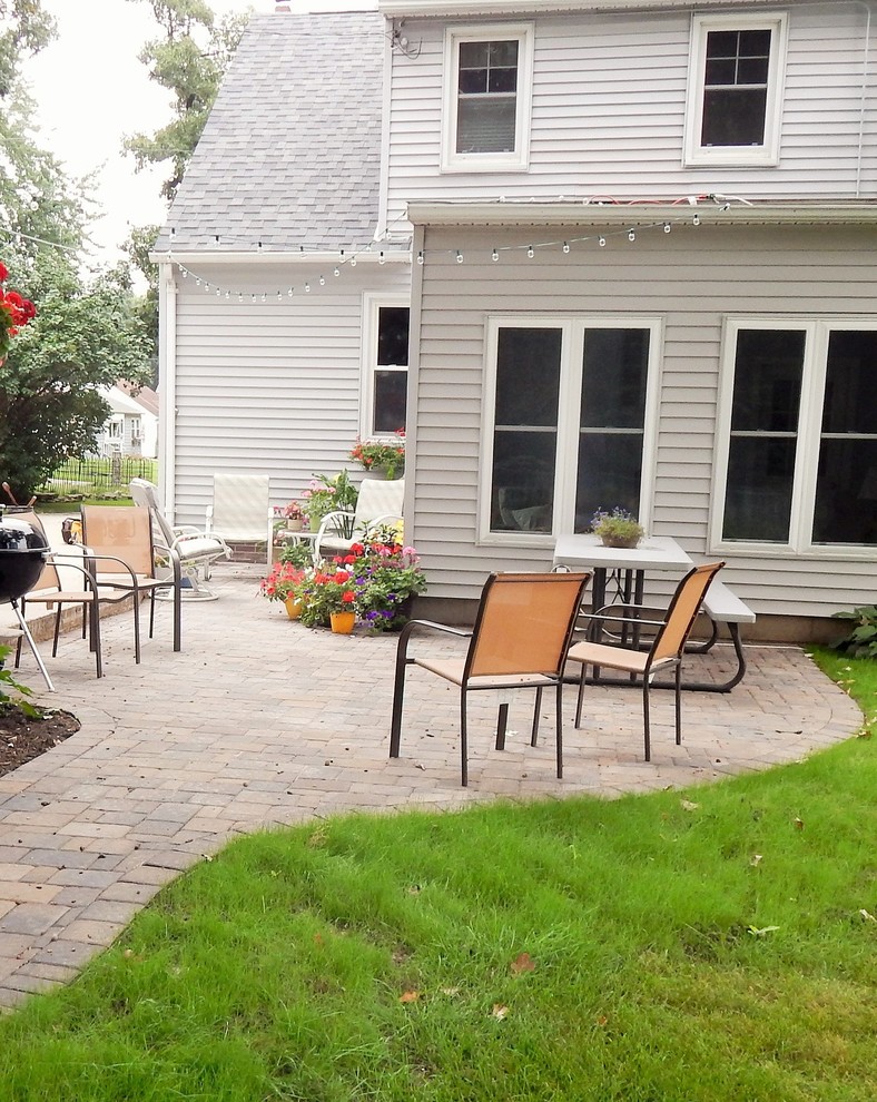 Mid-sized transitional backyard patio in Other with concrete pavers and no cover.