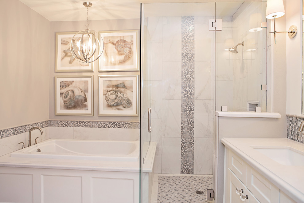 Drop-in bathtub - mid-sized transitional master gray tile and porcelain tile porcelain tile drop-in bathtub idea in Phoenix with an undermount sink, shaker cabinets, white cabinets, solid surface countertops, a two-piece toilet and gray walls