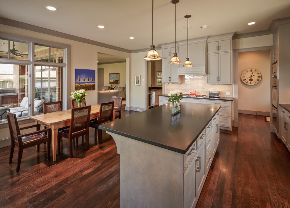 Large traditional eat-in kitchen in Houston with recessed-panel cabinets, grey cabinets, beige splashback, stainless steel appliances, a double-bowl sink, dark hardwood floors and with island.
