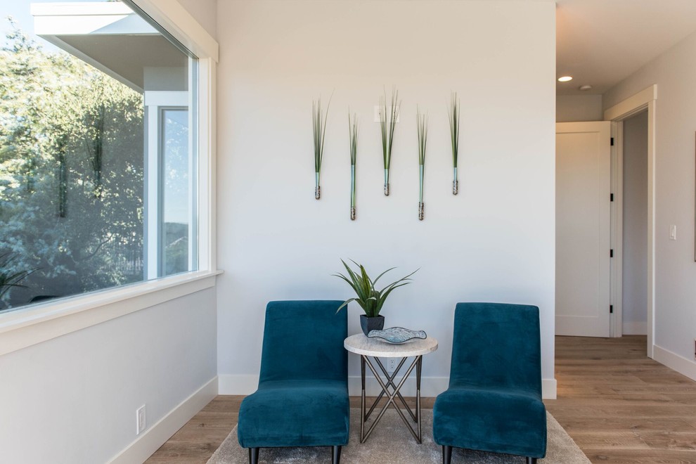 Transitional loft-style light wood floor home design photo in Orange County with no fireplace and gray walls
