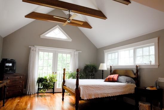 Large transitional master bedroom in Boston with grey walls, medium hardwood floors and no fireplace.