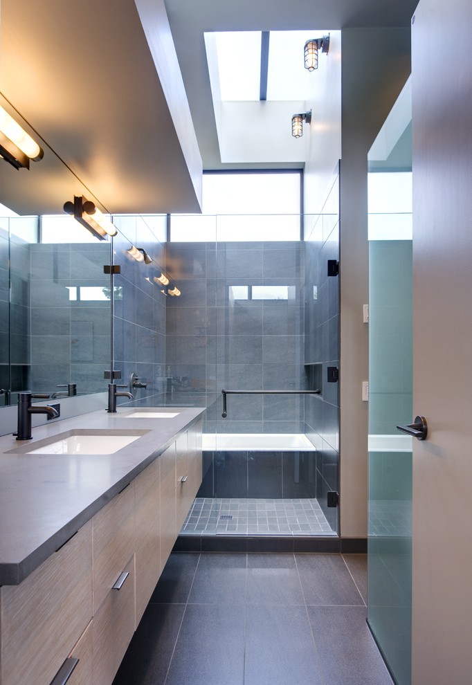 Photo of a mid-sized contemporary master bathroom in Seattle with an undermount sink, flat-panel cabinets, light wood cabinets, an alcove tub, an alcove shower, gray tile, stone tile, beige walls, slate floors, engineered quartz benchtops and grey benchtops.
