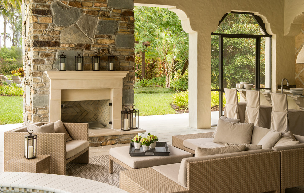 This is an example of a mediterranean patio in Orlando with with fireplace.