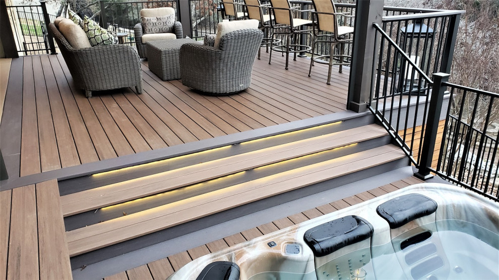 Deck - large rustic backyard second story metal railing deck idea in Austin with a roof extension