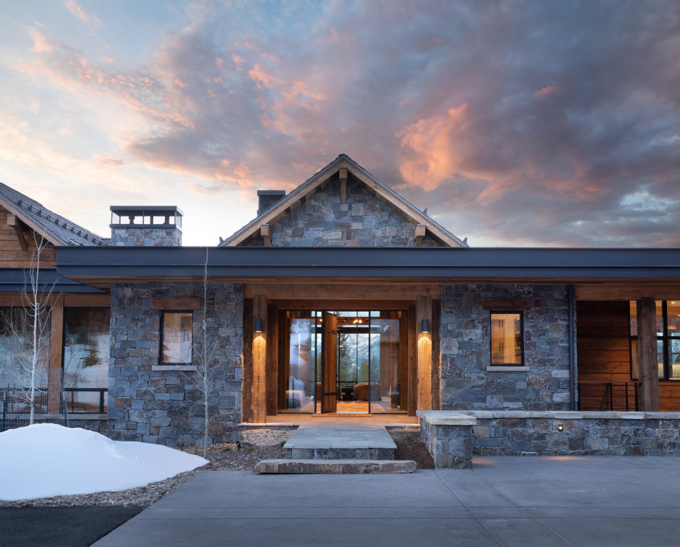 Mountain style pivot front door photo with a medium wood front door