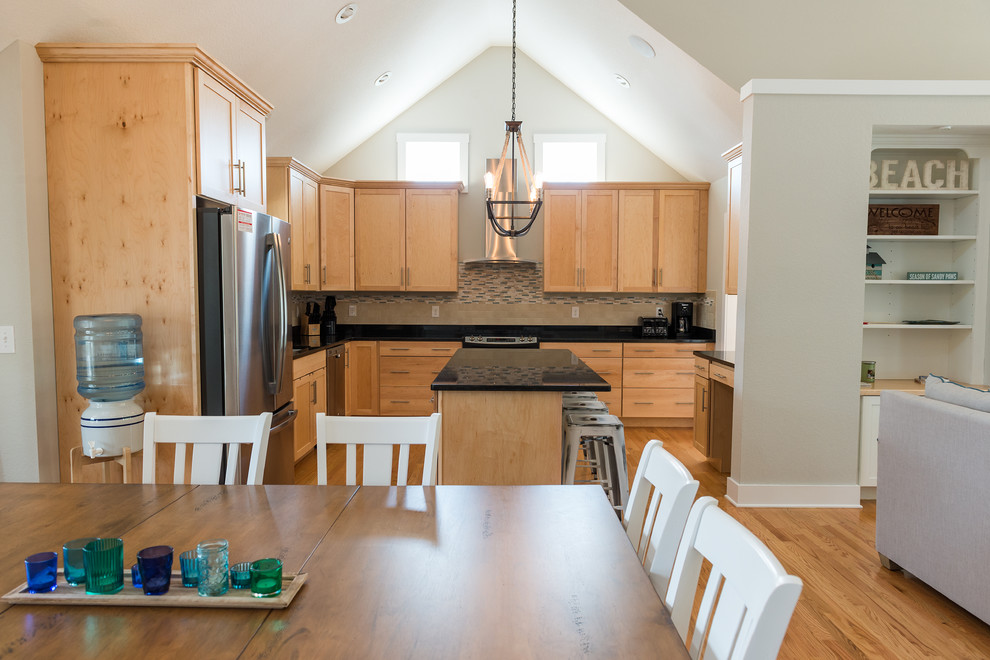 Kitchen - mid-sized transitional l-shaped light wood floor kitchen idea with an undermount sink, shaker cabinets, light wood cabinets, beige backsplash, subway tile backsplash, stainless steel appliances and an island