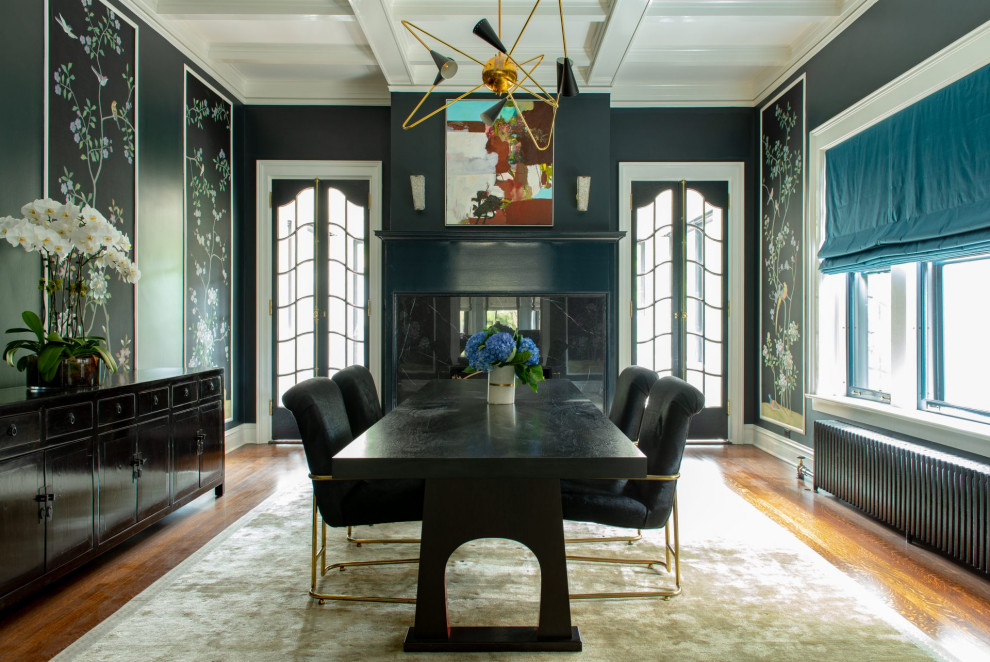 This is an example of a transitional separate dining room in Chicago with black walls, medium hardwood floors, brown floor and coffered.