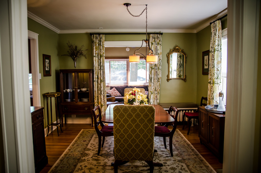 Mid-sized traditional separate dining room in Chicago with green walls, medium hardwood floors and no fireplace.