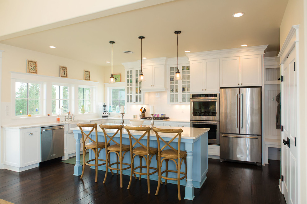 Design ideas for a mid-sized country eat-in kitchen in Portland with shaker cabinets, white cabinets, quartz benchtops, stainless steel appliances, dark hardwood floors and with island.
