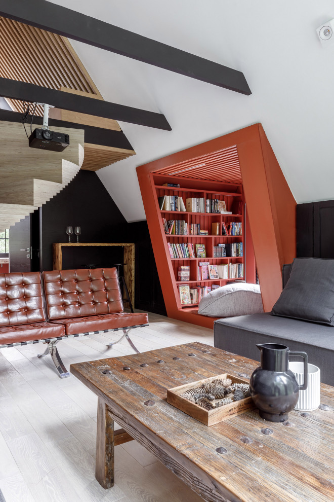Inspiration for an industrial living room in Other with a library, black walls, light hardwood floors and white floor.