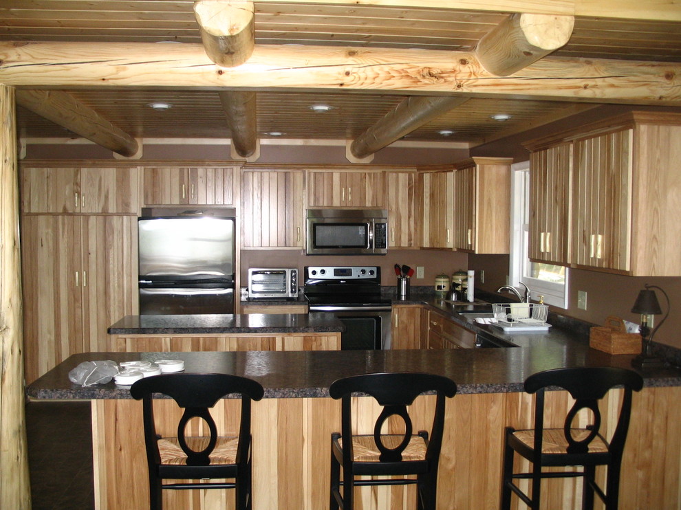 Mid-sized mountain style u-shaped porcelain tile and gray floor enclosed kitchen photo with an undermount sink, flat-panel cabinets, light wood cabinets, granite countertops, white appliances and a peninsula