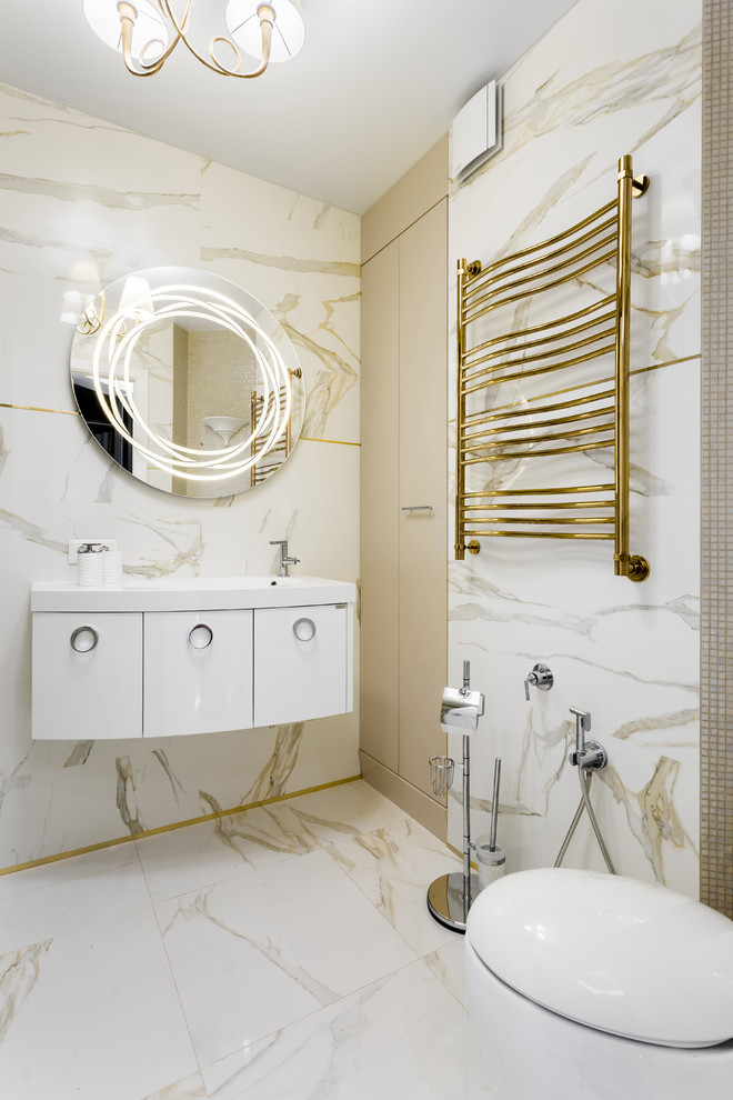Photo of a large contemporary bathroom in Other with flat-panel cabinets, white cabinets, white tile, ceramic tile, beige walls, porcelain floors, white floor, white benchtops, a two-piece toilet and an integrated sink.