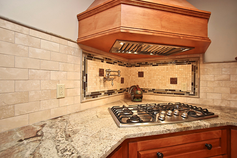 Eat-in kitchen - large rustic u-shaped medium tone wood floor eat-in kitchen idea in Milwaukee with a single-bowl sink, shaker cabinets, medium tone wood cabinets, granite countertops, beige backsplash, ceramic backsplash, stainless steel appliances and an island