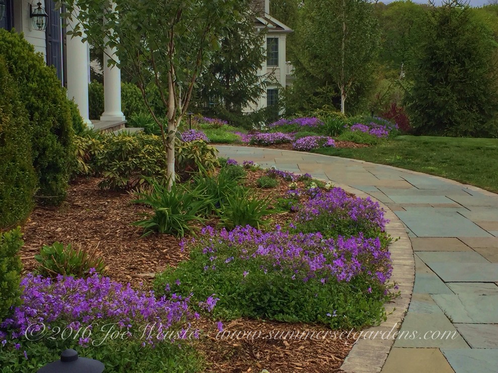 Mid-sized traditional front yard full sun garden in New York with a garden path and natural stone pavers.