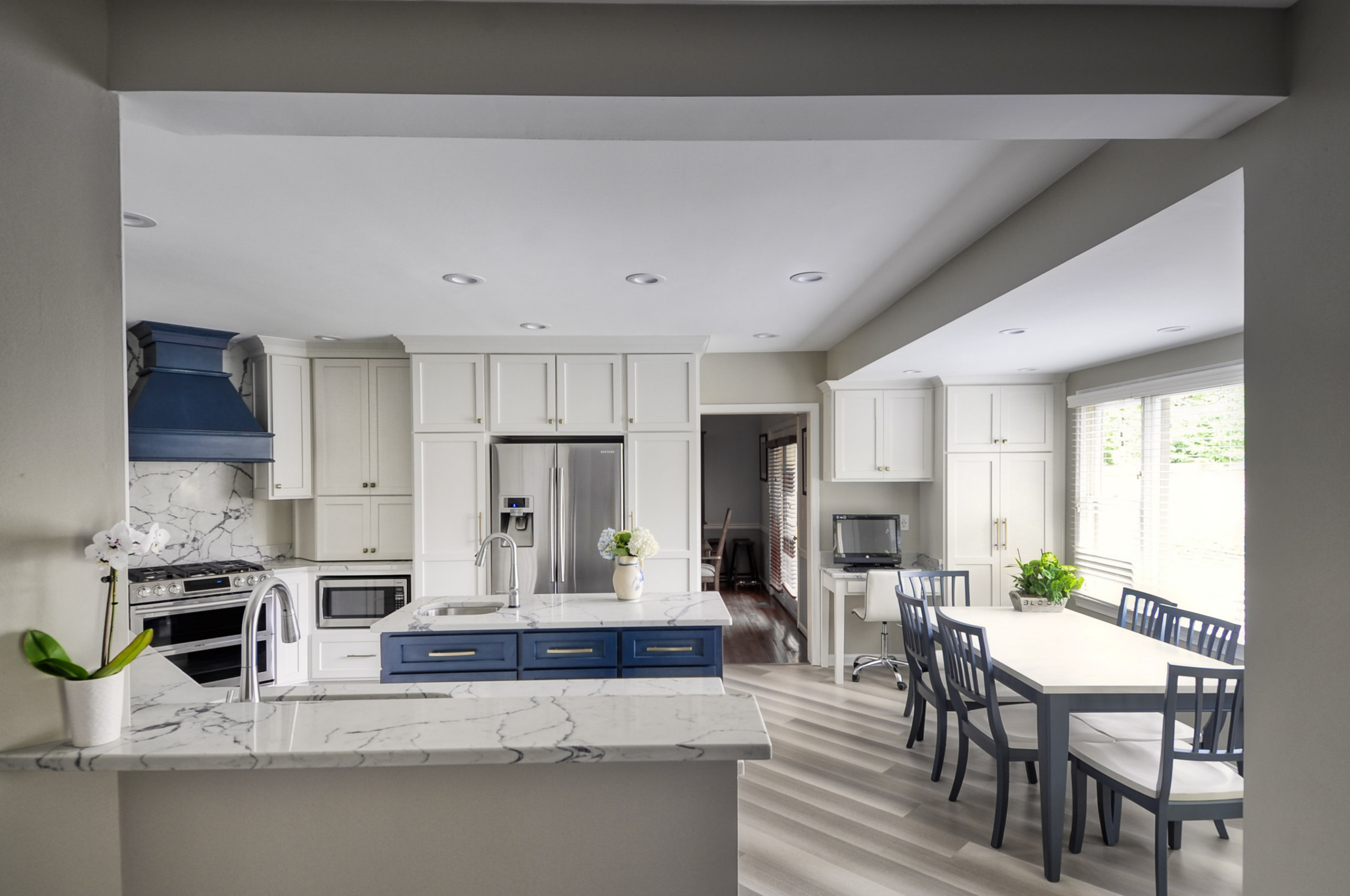 Navy Stained Island, Hood vent and Floating Shelves in White Shaker Kitchen