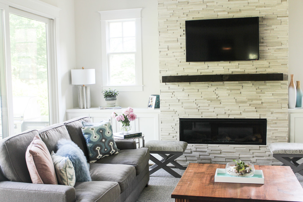 Inspiration for a mid-sized transitional open concept family room in DC Metro with grey walls, dark hardwood floors, a standard fireplace, a stone fireplace surround, a wall-mounted tv and brown floor.