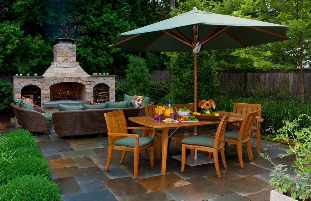 Contemporary patio in Chicago with natural stone pavers and a fire feature.